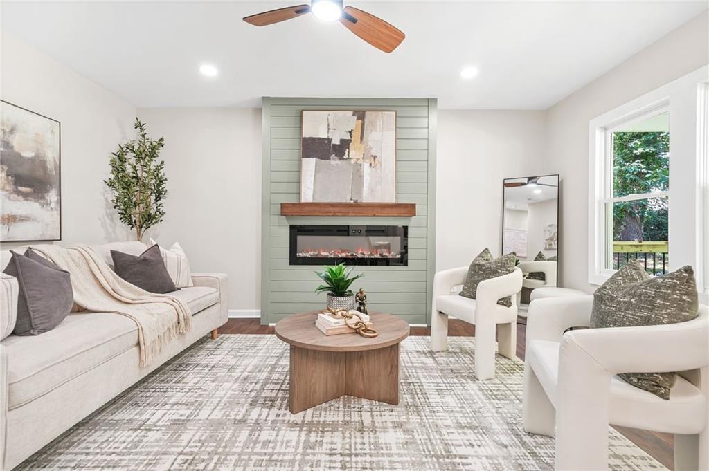 Staged living room with a sage green fireplace