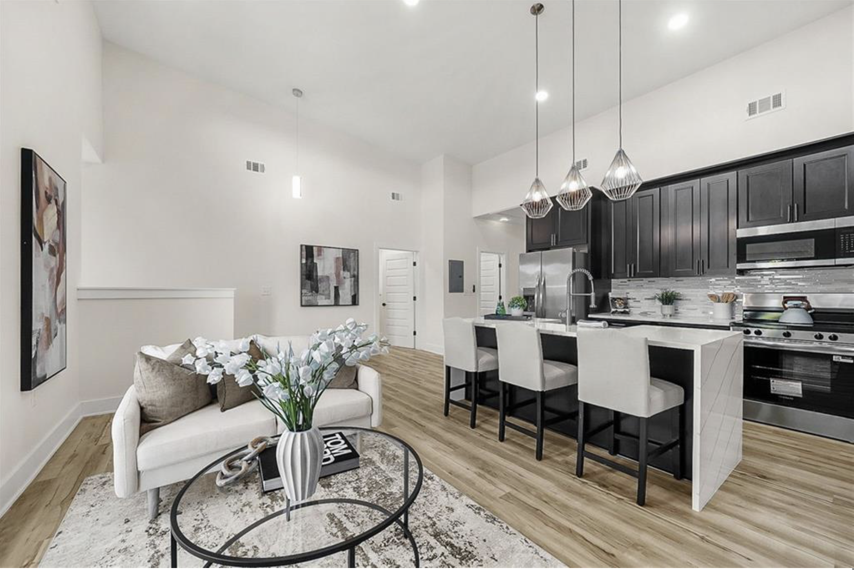 Staged open plan living room and kitchen with island seating