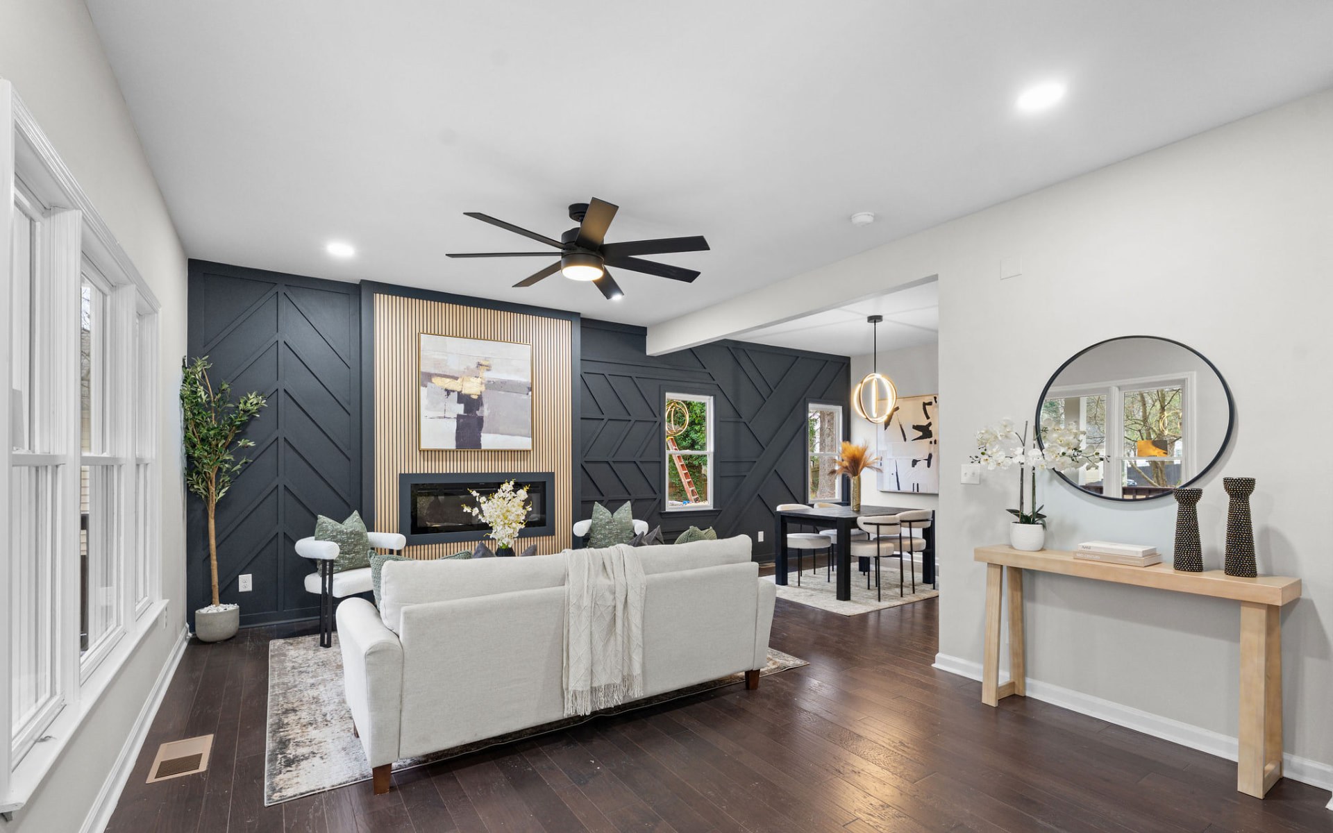 Staged great room with a dark shiplap accent wall