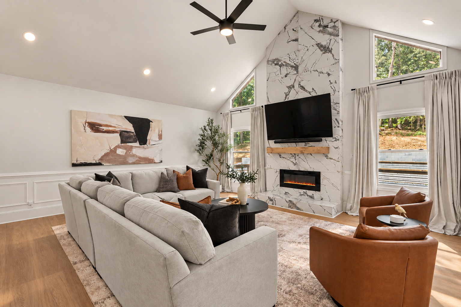 Professionally staged living room with marble fireplace